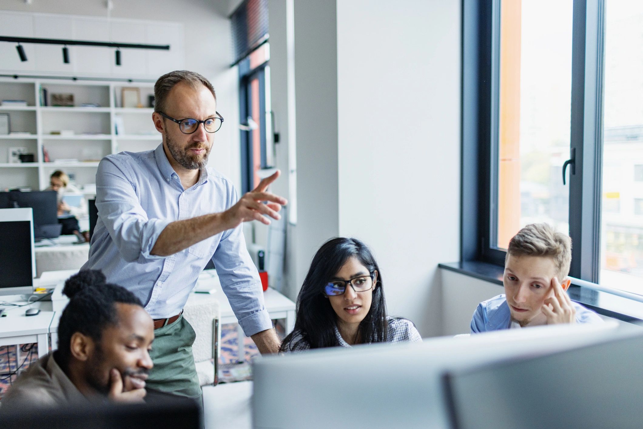 Professional discussing a project with colleagues